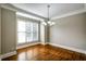 Bright dining room featuring hardwood floors, a modern chandelier, and a large window at 7 Chief Matthews Rd # 2A, Decatur, GA 30030