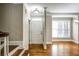 Inviting foyer featuring hardwood floors, a bright white door, and elegant trim details at 7 Chief Matthews Rd # 2A, Decatur, GA 30030