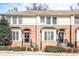 Charming townhome featuring a classic brick facade, black awnings, and well-maintained landscaping at 7 Chief Matthews Rd # 2A, Decatur, GA 30030