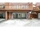 Townhouse garages with doors and elevated decks with wooden rails at 7 Chief Matthews Rd # 2A, Decatur, GA 30030