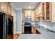 Functional kitchen featuring natural wood cabinets, sleek appliances, and ample counter space at 7 Chief Matthews Rd # 2A, Decatur, GA 30030