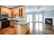 Open-concept kitchen flowing into a living area with stainless steel appliances and granite countertops at 7 Chief Matthews Rd # 2A, Decatur, GA 30030