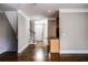 Open-concept living area featuring hardwood floors, crown molding, and stairs leading to the upper level of the house at 7 Chief Matthews Rd # 2A, Decatur, GA 30030