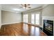 Bright living room with fireplace, hardwood floors, crown molding, and glass doors to the deck offers inviting space at 7 Chief Matthews Rd # 2A, Decatur, GA 30030