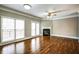 Spacious living room with a fireplace, hardwood floors, ceiling fan, and access to an outdoor deck through glass doors at 7 Chief Matthews Rd # 2A, Decatur, GA 30030
