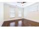 Bright bedroom features hardwood floors, ceiling fan, and natural light from three windows at 745 Fountainhead Ne Ln # 112, Atlanta, GA 30324