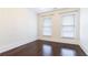 Cozy bedroom with dark hardwood floors, white walls, and two bright windows at 745 Fountainhead Ne Ln # 112, Atlanta, GA 30324