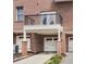Brick townhome features garage, balcony, and a tidy front lawn and landscaped entrance at 745 Fountainhead Ne Ln # 112, Atlanta, GA 30324
