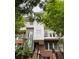 Contemporary multi-story townhouse featuring a red brick facade and upper-level balcony at 745 Fountainhead Ne Ln # 112, Atlanta, GA 30324