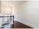 Well-lit hallway with dark hardwood floors and a view of the staircase and windows at 745 Fountainhead Ne Ln # 112, Atlanta, GA 30324