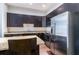 Modern kitchen with stainless steel appliances, granite countertops, and dark cabinetry at 745 Fountainhead Ne Ln # 112, Atlanta, GA 30324