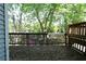 Wooden back deck offers ample space for outdoor seating and views of lush trees and landscaping at 1102 Wedgewood Way, Atlanta, GA 30350