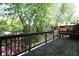 Wooden back deck with wooden railing offers views of trees and landscaping at 1102 Wedgewood Way, Atlanta, GA 30350