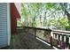 View of wooden back deck showing railing, trees, and landscaping from exterior of home at 1102 Wedgewood Way, Atlanta, GA 30350