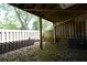 Backyard space with a wooden fence, trees, and coverage from the deck above at 1102 Wedgewood Way, Atlanta, GA 30350