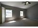 Spacious bedroom with two windows, neutral carpet, ceiling fan, and ensuite bath at 1102 Wedgewood Way, Atlanta, GA 30350