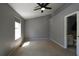 Large bedroom with neutral walls, carpet, ceiling fan, and ensuite bathroom at 1102 Wedgewood Way, Atlanta, GA 30350