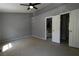 Bedroom with neutral walls and carpet showing ceiling fan and view into ensuite bathroom at 1102 Wedgewood Way, Atlanta, GA 30350