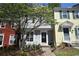 Charming two-story townhome featuring a well-maintained lawn and beautiful landscaping with a blooming tree at 1102 Wedgewood Way, Atlanta, GA 30350