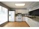 Well-lit kitchen with white cabinets, granite countertops, and modern appliances, perfect for cooking at 1102 Wedgewood Way, Atlanta, GA 30350