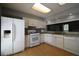 Bright kitchen featuring white appliances, ample countertop space, and plenty of storage, ready for use at 1102 Wedgewood Way, Atlanta, GA 30350