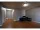 Living room featuring wood flooring and access to a hallway with two doors at 1102 Wedgewood Way, Atlanta, GA 30350