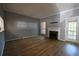 Spacious living room with wood floors, a fireplace, and plenty of natural light, ideal for relaxation at 1102 Wedgewood Way, Atlanta, GA 30350