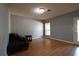 Living room featuring wood flooring, a window, and access to an exterior door at 1102 Wedgewood Way, Atlanta, GA 30350