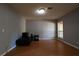 Living room featuring wood flooring, a window, and access to an exterior door at 1102 Wedgewood Way, Atlanta, GA 30350