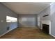 Open-concept living room with wood floors, a cozy fireplace, and views into the kitchen, perfect for gatherings at 1102 Wedgewood Way, Atlanta, GA 30350