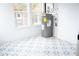 Bright basement featuring patterned tile floor and modern water heater at 1395 Winburn Dr, East Point, GA 30344