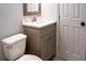 Bathroom featuring a new vanity with a sink, a toilet, and a modern door, with neutral wall paint at 1395 Winburn Dr, East Point, GA 30344