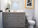 Modern bathroom with gray vanity, light countertop, and contemporary fixtures and hardware at 1395 Winburn Dr, East Point, GA 30344
