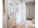 Inviting entryway with hardwood floors, a windowed front door, and neutral paint throughout at 1395 Winburn Dr, East Point, GA 30344