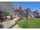 Charming brick home featuring a manicured lawn, covered parking, and classic architectural details at 1395 Winburn Dr, East Point, GA 30344