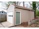 Detached single car garage with white door, plus side access door to the fenced backyard at 1395 Winburn Dr, East Point, GA 30344