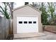 A single-car detached garage with a white door providing parking and storage at 1395 Winburn Dr, East Point, GA 30344