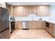 Kitchen boasts stainless steel appliances, light countertops, and backsplash at 1395 Winburn Dr, East Point, GA 30344