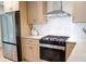 Kitchen features stainless steel appliances, sleek range hood and gas range at 1395 Winburn Dr, East Point, GA 30344