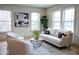 Bright and airy living room with large windows, modern furniture, and hardwood floors at 1395 Winburn Dr, East Point, GA 30344
