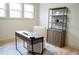 Bright home office with wood floors, lots of natural light, and a desk with modern bookshelf at 1395 Winburn Dr, East Point, GA 30344