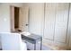 Office space with modern desk and chair, featuring a wall with a closet, and neutral colors at 1395 Winburn Dr, East Point, GA 30344