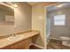 Bathroom featuring a light-colored sink and vanity with tile flooring and a window to bring in natural light at 2264 Pryor Rd, Atlanta, GA 30315