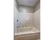A bathtub and shower combination with a showerhead and faucet, enclosed with white tiling on the walls at 2264 Pryor Rd, Atlanta, GA 30315