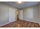 This bedroom has dark wood-patterned floors, light gray walls, and a door leading into the laundry room at 2264 Pryor Rd, Atlanta, GA 30315