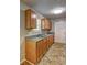 Well-lit kitchen features wood cabinets, double sinks, and tile flooring at 2264 Pryor Rd, Atlanta, GA 30315