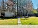 This spacious backyard features a shed, firepit, and mature trees for privacy at 2499 Sinclair Trce, Powder Springs, GA 30127