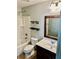 Bathroom featuring a vanity sink, a shower-tub, and storage shelves at 2499 Sinclair Trce, Powder Springs, GA 30127