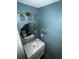 Stylish powder room featuring trendy light fixtures, an decorative mirror, and modern finishes at 2499 Sinclair Trce, Powder Springs, GA 30127