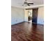 This spacious primary bedroom features wood floors, a ceiling fan, and a barn door to the en-suite bathroom at 2499 Sinclair Trce, Powder Springs, GA 30127